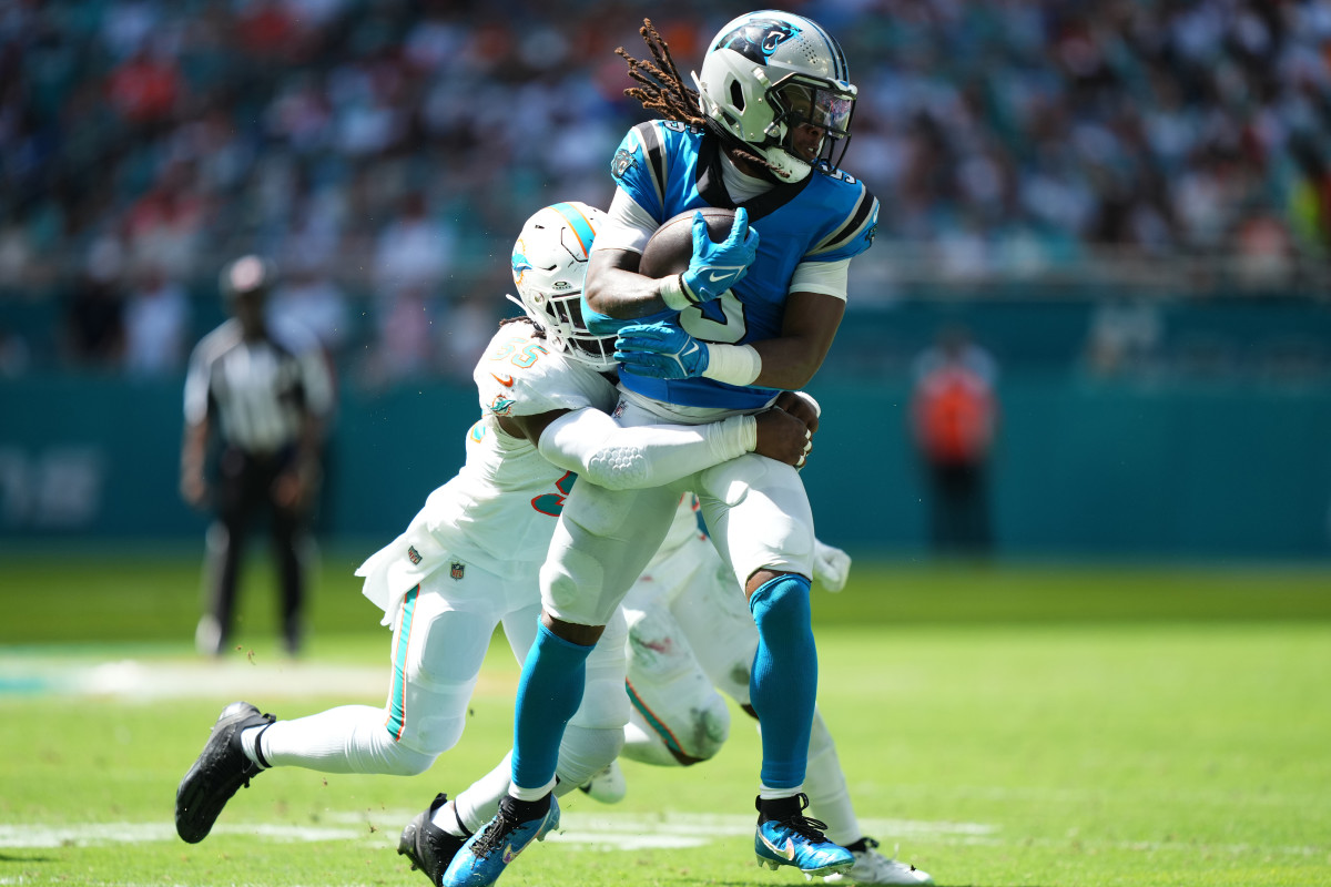Miami Dolphins linebacker Jerome Baker (55) tackles Carolina Panthers wide receiver Laviska Shenault Jr. (5) during the first half at Hard Rock Stadium. 